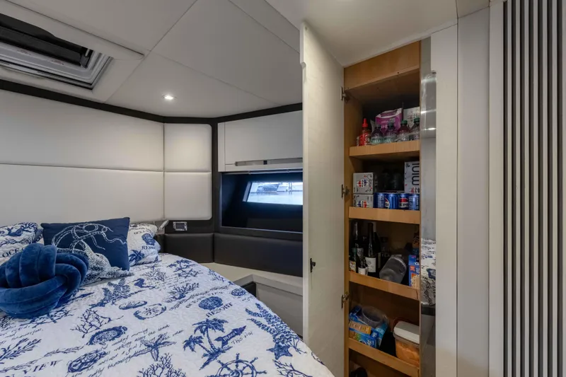 Treasure X Yacht Photos Pics Luxurious cabin interior of 2015 Azimut 55S yacht with bed and storage.