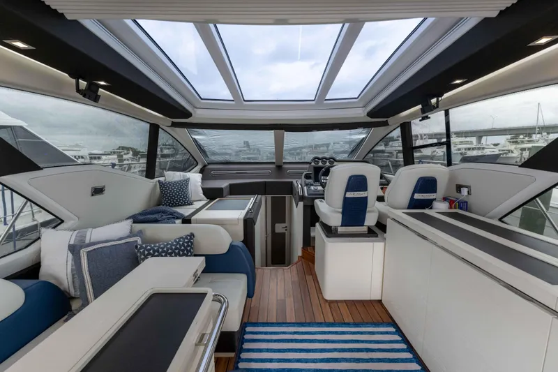 Treasure X Yacht Photos Pics Luxurious interior of a 2015 Azimut 55S yacht with modern seating and panoramic windows.