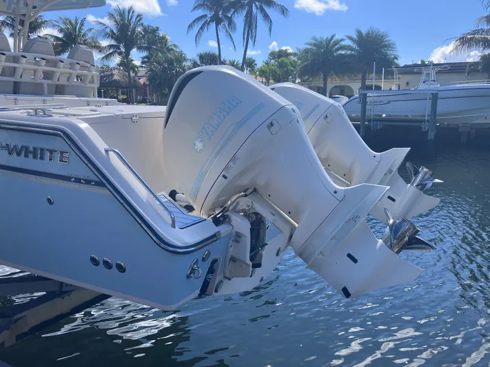  Yacht Photos Pics 2018 Grady-White Canyon 336 boat with twin outboard engines docked by palm trees.