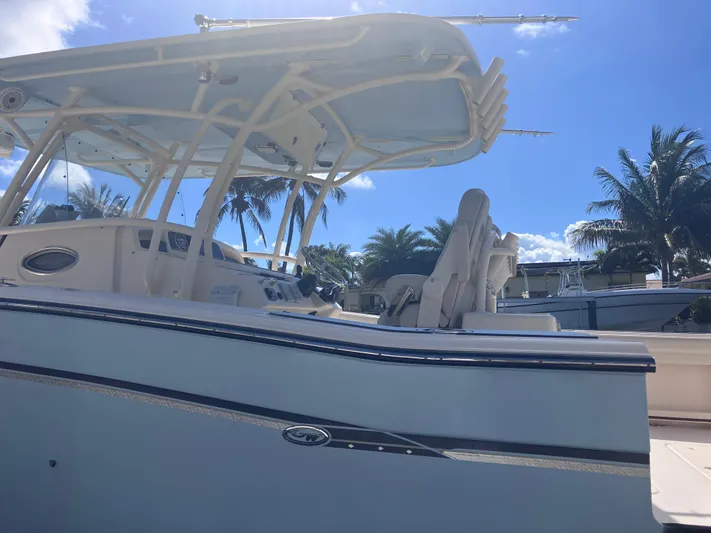  Yacht Photos Pics 2018 Grady-White Canyon 336 boat with T-top, docked under clear blue sky.