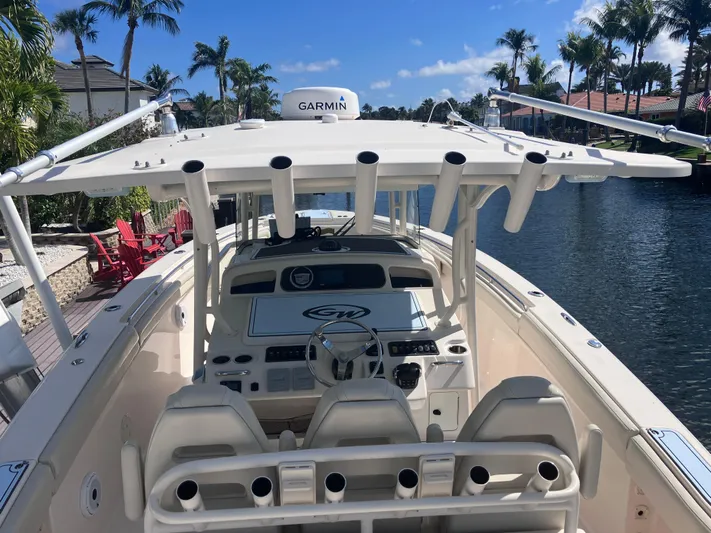  Yacht Photos Pics 2018 Grady-White Canyon 336 boat on a sunny canal with palm trees.