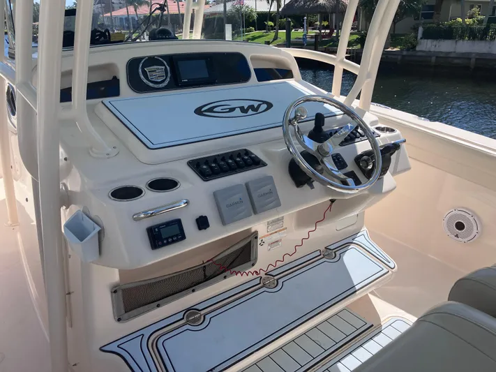  Yacht Photos Pics 2018 Grady-White Canyon 336 boat helm with steering wheel and control panel.