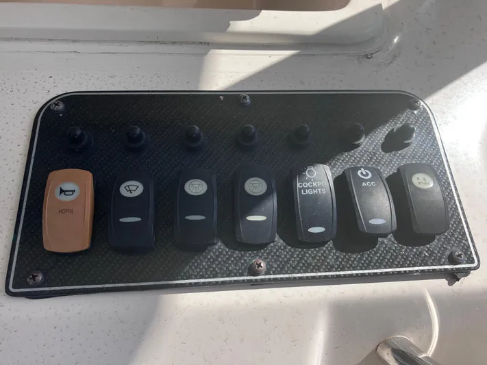  Yacht Photos Pics Control panel of a 2018 Grady-White Canyon 336 boat with labeled switches.