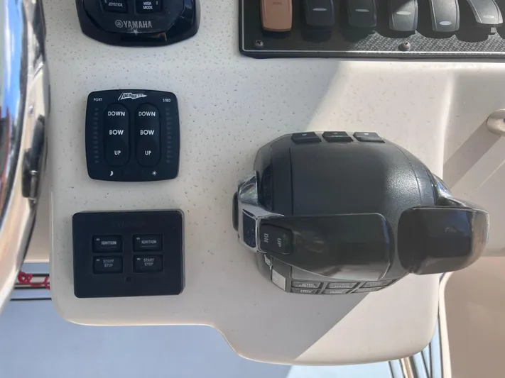  Yacht Photos Pics Control panel of a 2018 Grady-White Canyon 336 boat with throttle and trim tabs.
