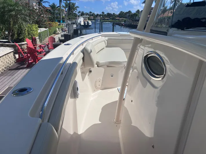  Yacht Photos Pics 2018 Grady-White Canyon 336 boat, spacious deck, docked near waterfront homes.