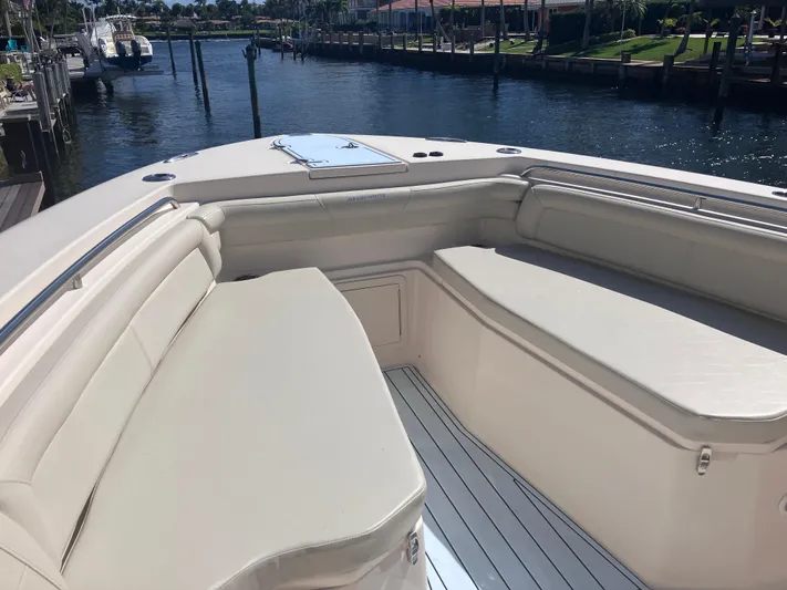  Yacht Photos Pics 2018 Grady-White Canyon 336 boat interior with cushioned seating by the water.