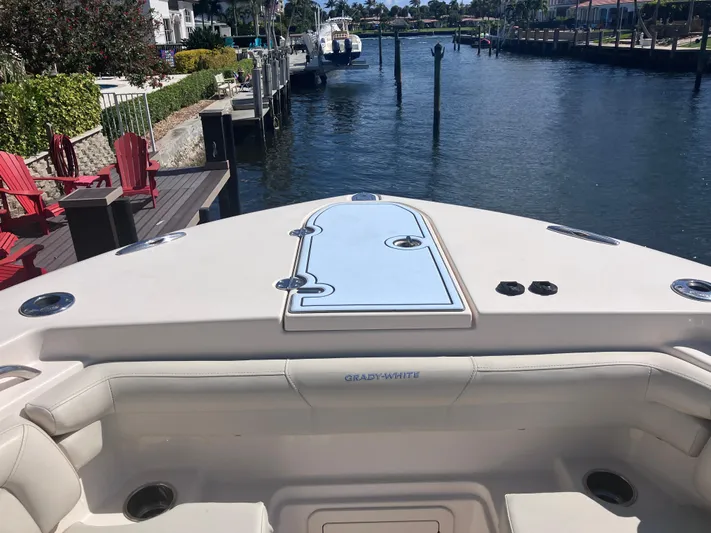 Yacht Photos Pics 2018 Grady-White Canyon 336 boat docked by a scenic waterfront.