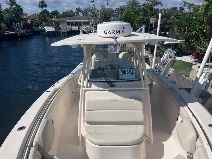  Yacht Photos Pics 2018 Grady-White Canyon 336 boat for sale, docked near waterfront homes.