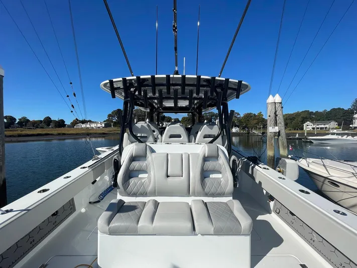 Tunnel Vision Yacht Photos Pics 2024 Freeman 42LR boat with cushioned seating, docked in a serene marina setting.