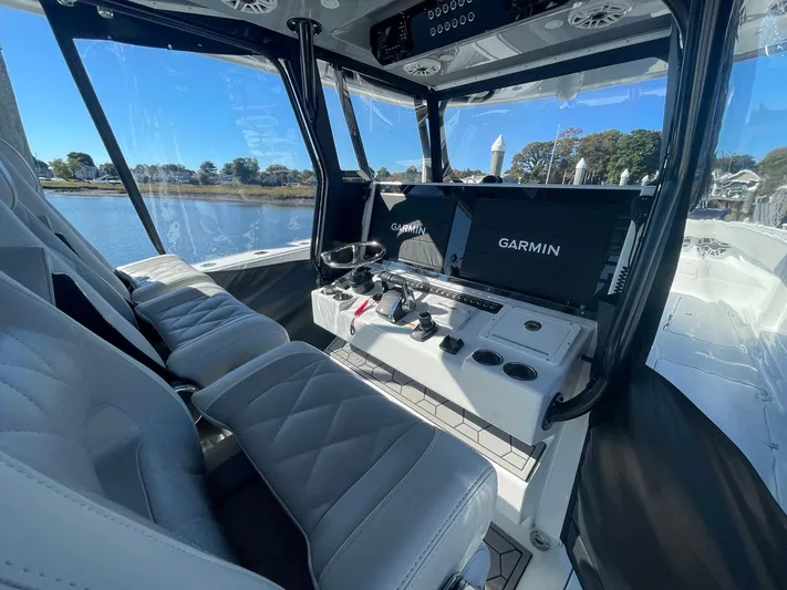 Tunnel Vision Yacht Photos Pics Interior of 2024 Freeman 42LR boat with Garmin navigation system and luxurious seating.