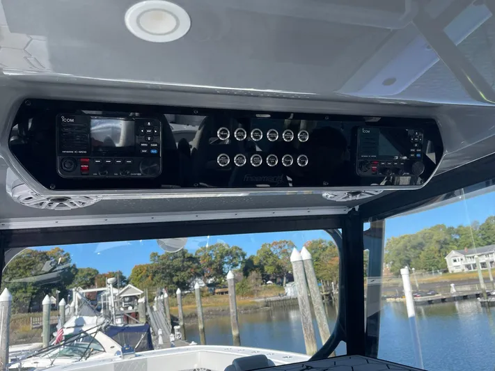 Tunnel Vision Yacht Photos Pics 2024 Freeman 42LR boat dashboard with control panels and gauges at a marina.