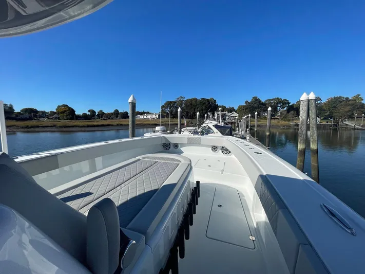 Tunnel Vision Yacht Photos Pics 2024 Freeman 42LR boat docked, featuring spacious seating and sleek design under clear blue skies.