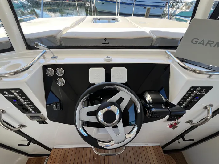 Yacht Photos Pics 2024 Tuna catamaran helm with modern steering wheel and navigation controls.