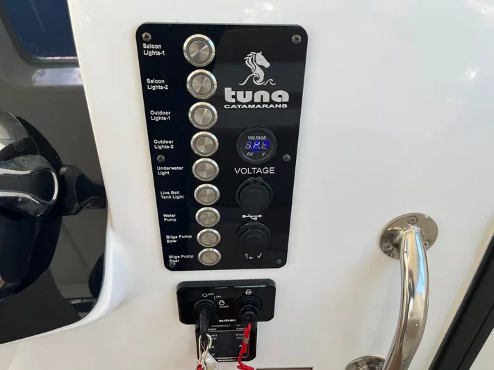  Yacht Photos Pics Control panel of 2024 Tuna catamaran with voltage display and labeled switches.