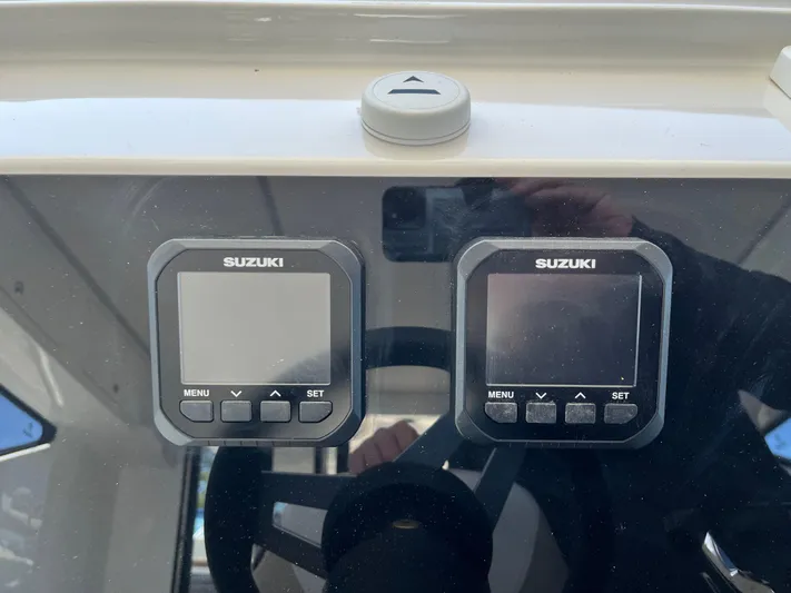  Yacht Photos Pics 2024 Tuna catamaran dashboard with Suzuki digital displays and steering wheel.
