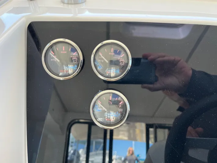  Yacht Photos Pics 2024 Tuna catamaran dashboard with three fuel and temperature gauges.