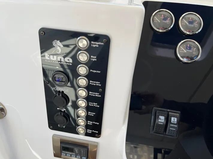  Yacht Photos Pics 2024 Tuna catamaran control panel with navigation and utility switches.