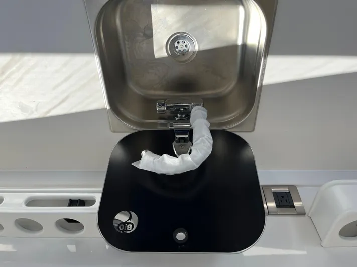  Yacht Photos Pics Stainless steel sink on 2024 Tuna catamaran with modern faucet and black cover.