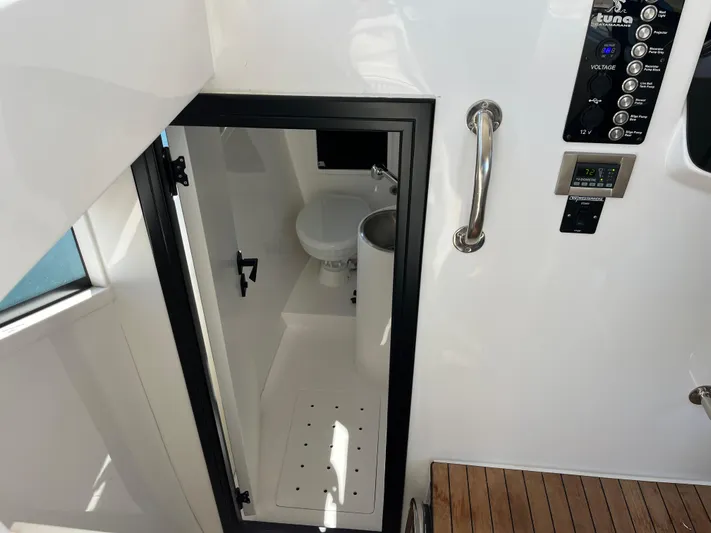  Yacht Photos Pics 2024 Tuna catamaran bathroom with modern fixtures and sleek design.