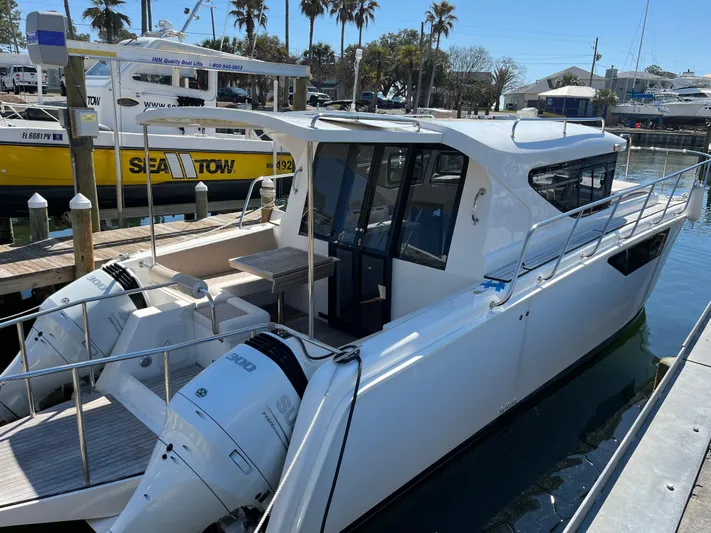  Yacht Photos Pics 2024 Tuna catamaran docked at marina with dual outboard engines.