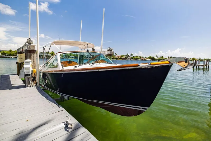  Yacht Photos Pics 2004 Hinckley Talaria 29 R docked on clear water under blue sky.