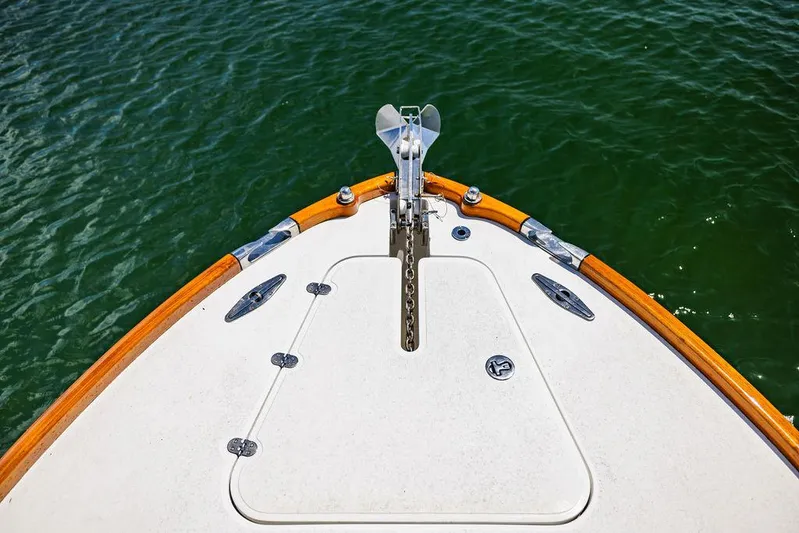  Yacht Photos Pics Bow of 2004 Hinckley Talaria 29 R boat on water, featuring anchor and teak trim.