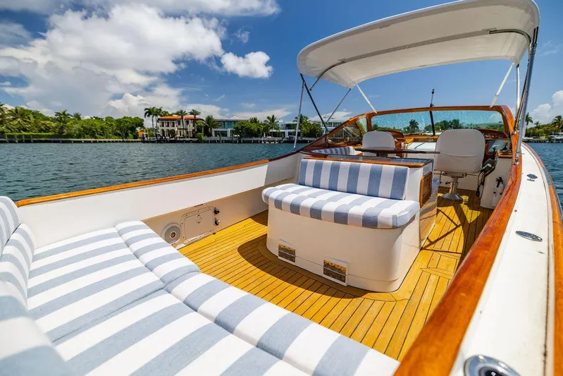  Yacht Photos Pics 2004 Hinckley Talaria 29 R boat with striped seating, cruising on a sunny day.