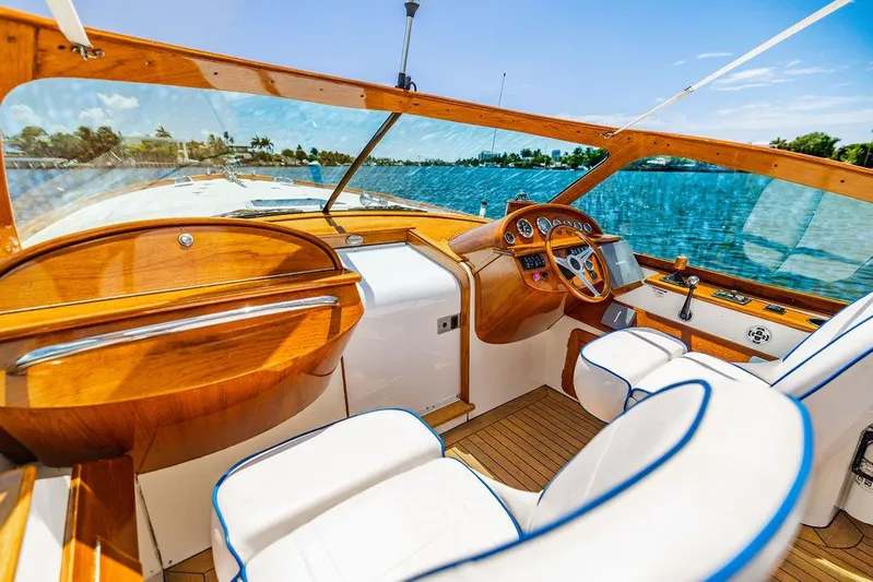  Yacht Photos Pics Luxurious 2004 Hinckley Talaria 29 R boat interior with wooden dashboard and white seating.