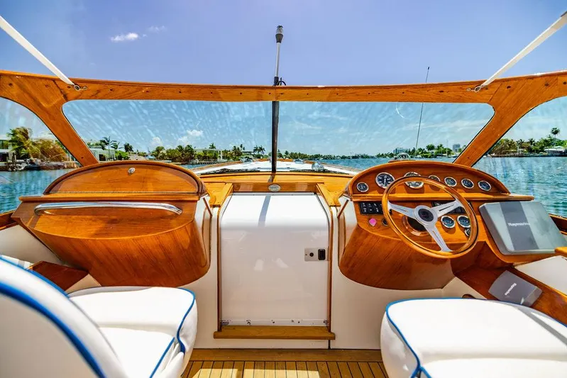  Yacht Photos Pics 2004 Hinckley Talaria 29 R boat cockpit with wooden dashboard and scenic water view.
