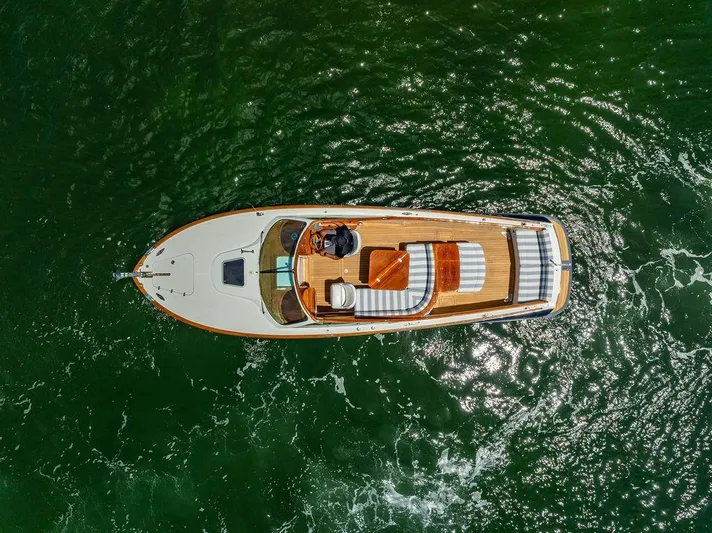 Yacht Photos Pics Aerial view of 2004 Hinckley Talaria 29 R boat on green water.