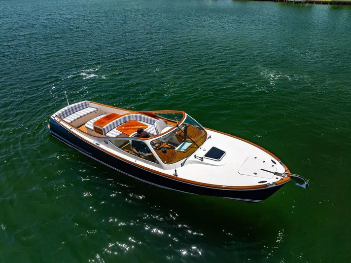  Yacht Photos Pics 2004 Hinckley Talaria 29 R boat on calm green water.