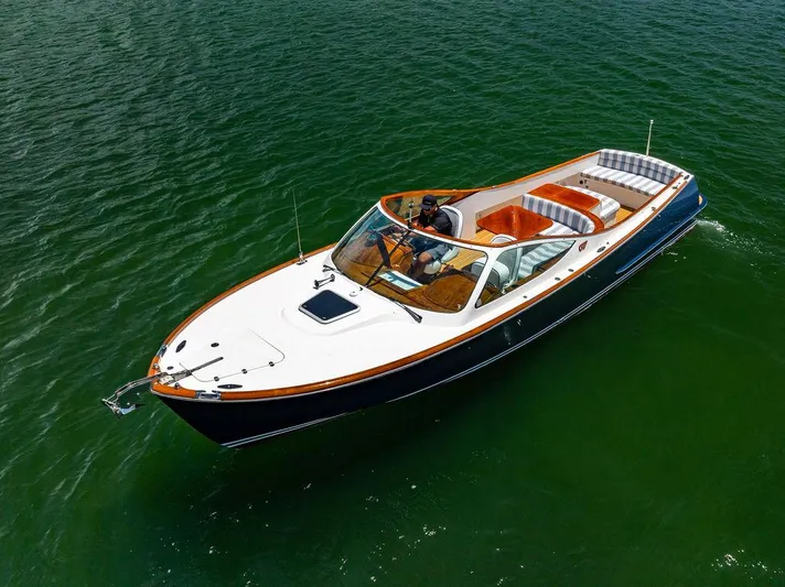  Yacht Photos Pics 2004 Hinckley Talaria 29 R boat cruising on calm green waters.