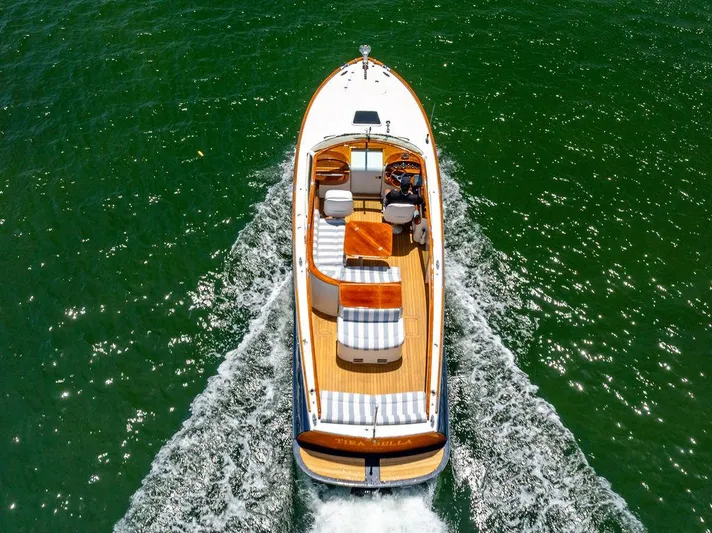  Yacht Photos Pics 2004 Hinckley Talaria 29 R cruising on vibrant green water, aerial view.