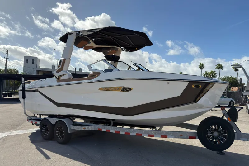  Yacht Photos Pics 2025 Nautique Super Air Nautique G25 Paragon boat on trailer under blue sky.