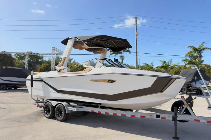  Yacht Photos Pics 2025 Nautique Super Air Nautique G25 Paragon boat on trailer, sunny day, palm trees background.