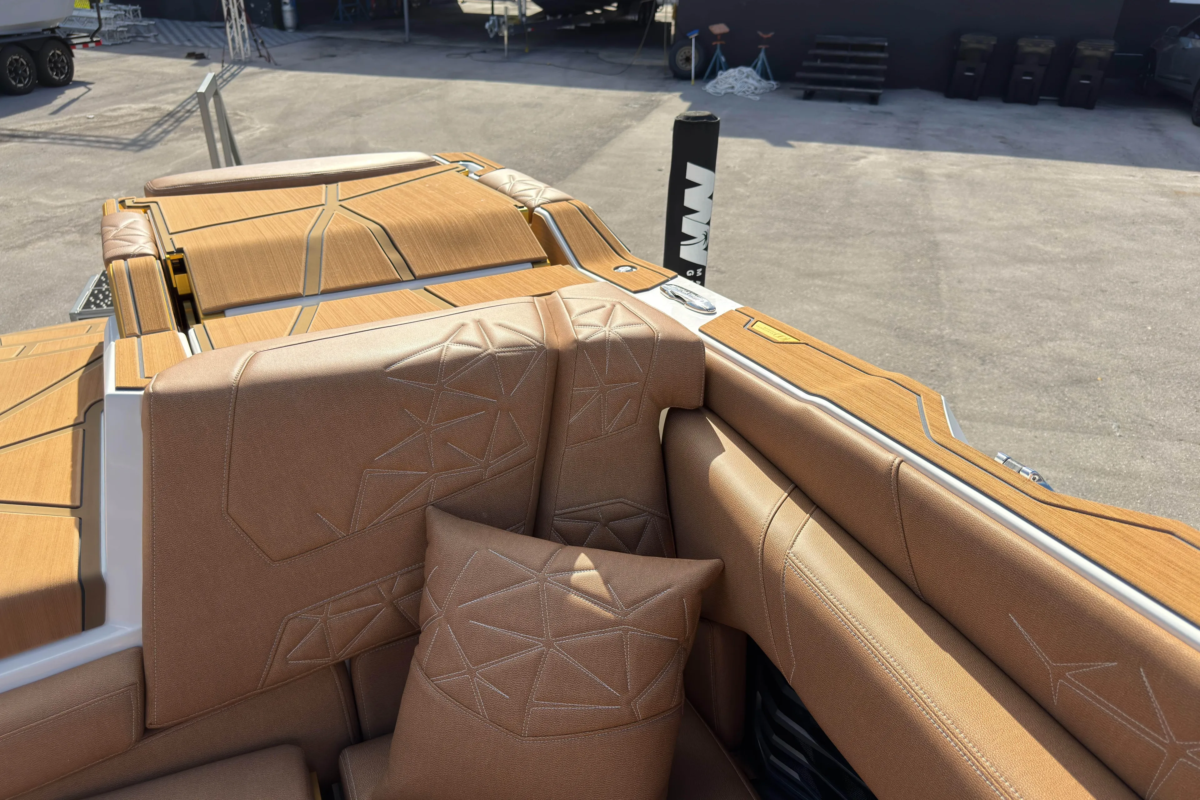  Yacht Photos Pics 2025 Nautique Super Air Nautique G25 Paragon interior with tan upholstery and geometric stitching.