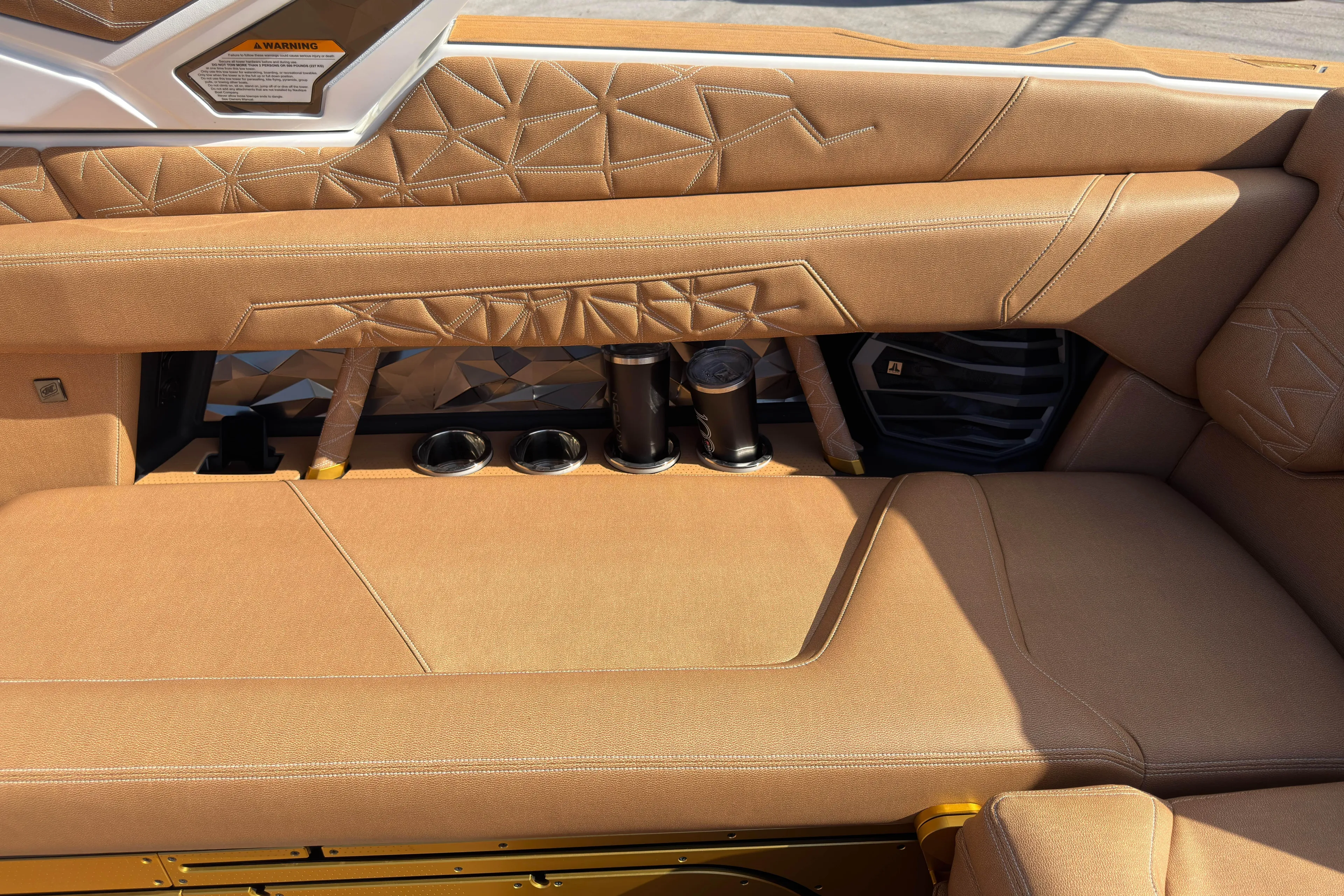  Yacht Photos Pics Luxurious interior of 2025 Nautique Super Air Nautique G25 Paragon with tan upholstery and cup holders.