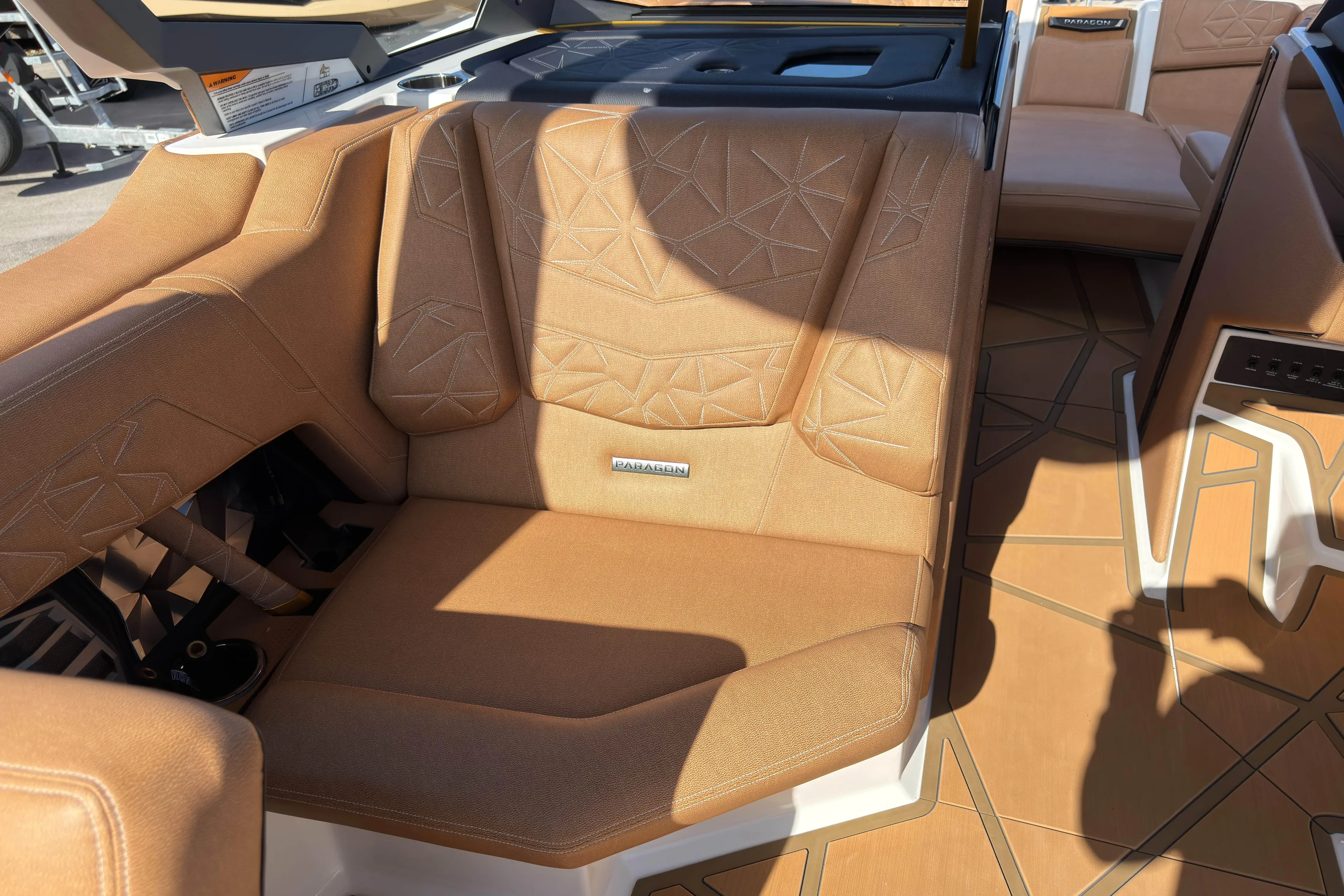  Yacht Photos Pics 2025 Nautique Super Air Nautique G25 Paragon interior with tan upholstery and geometric design.