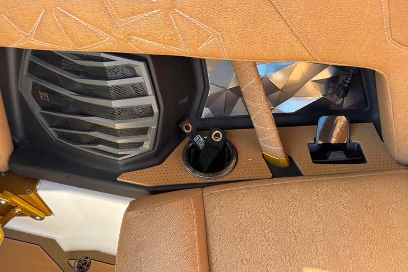  Yacht Photos Pics 2025 Nautique Super Air Nautique G25 Paragon interior detail with speaker and cup holder.