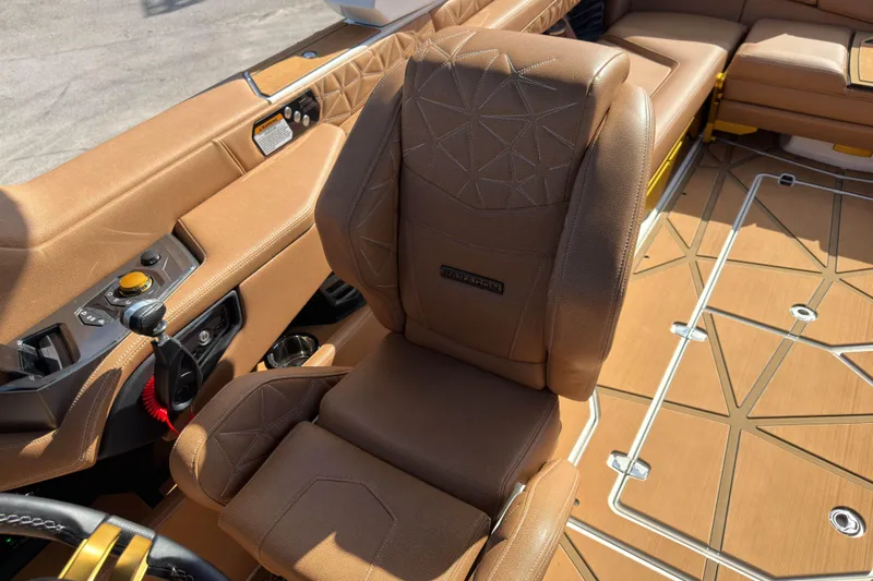  Yacht Photos Pics 2025 Nautique Super Air Nautique G25 Paragon interior with luxurious brown seating and controls.
