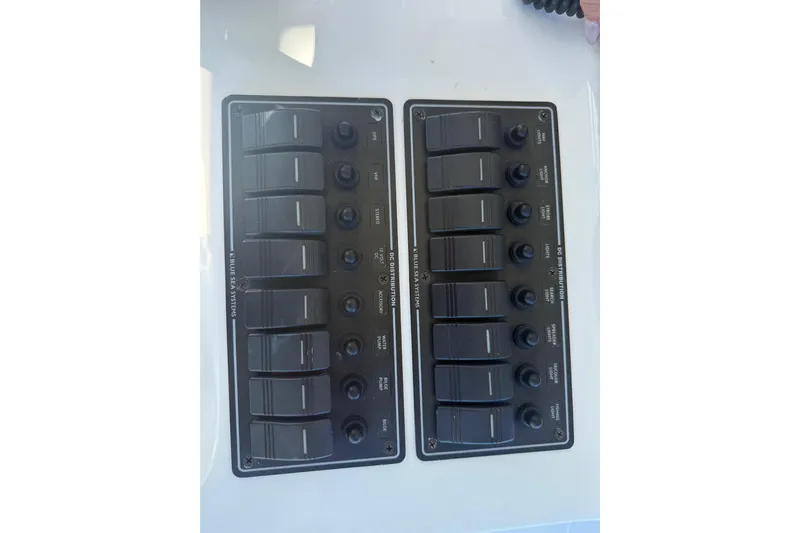  Yacht Photos Pics Control panel of a 2016 Extreme Boats 38 Cuddy Cabin with labeled switches.