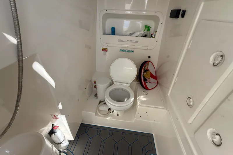  Yacht Photos Pics 2016 Extreme Boats 38 Cuddy Cabin bathroom with toilet, storage, and fire extinguisher.