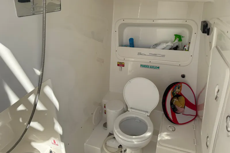  Yacht Photos Pics 2016 Extreme Boats 38 Cuddy Cabin bathroom with toilet, shower, and storage shelf.