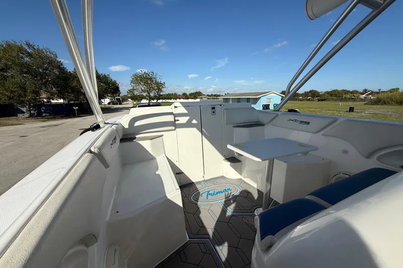  Yacht Photos Pics 2016 Extreme Boats 38 Cuddy Cabin interior with seating and table, under clear blue sky.