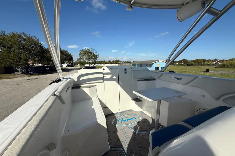  Yacht Photos Pics 2016 Extreme Boats 38 Cuddy Cabin interior with seating and table, under clear blue sky.