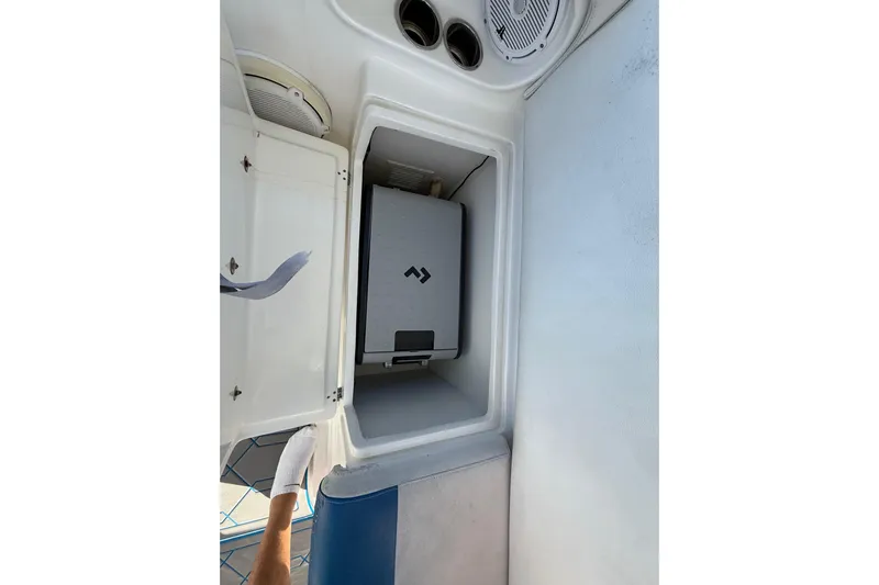  Yacht Photos Pics 2016 Extreme Boats 38 Cuddy Cabin interior storage compartment with open door.