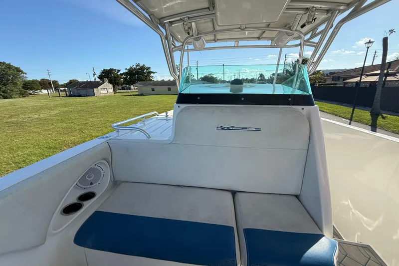 Yacht Photos Pics 2016 Extreme Boats 38 Cuddy Cabin interior with seating and windshield, parked on grass.