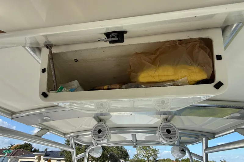  Yacht Photos Pics Open storage compartment on 2016 Extreme Boats 38 Cuddy Cabin, containing various items.