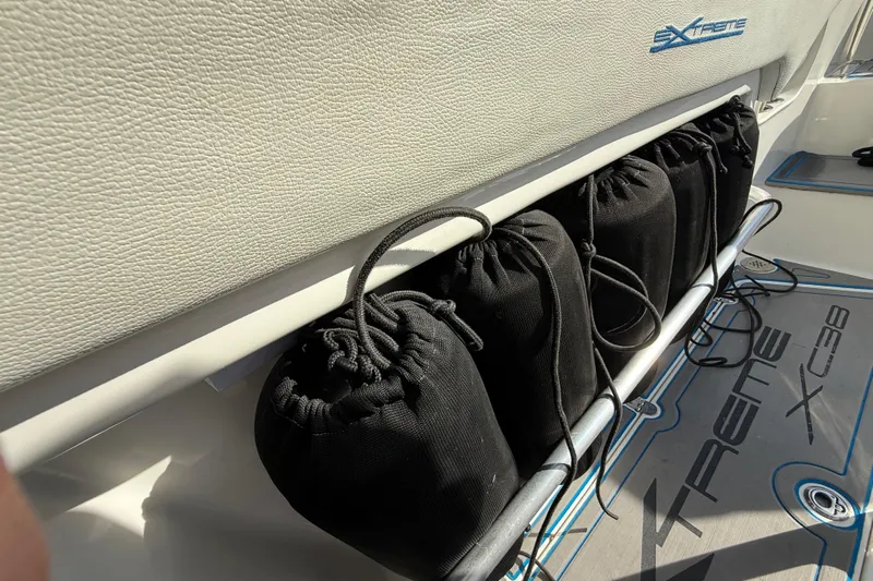  Yacht Photos Pics Storage area on 2016 Extreme Boats 38 Cuddy Cabin with black bags and branded flooring.