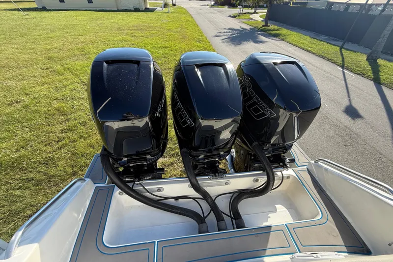  Yacht Photos Pics 2016 Extreme Boats 38 Cuddy Cabin with triple outboard engines, parked on grass.